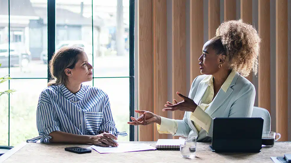 a meeting between 2 people in a work setting