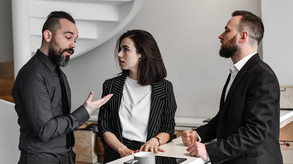 Group of 3 coworkers engaged in conversation