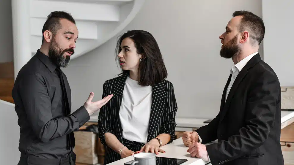 Group of 3 coworkers engaged in conversation