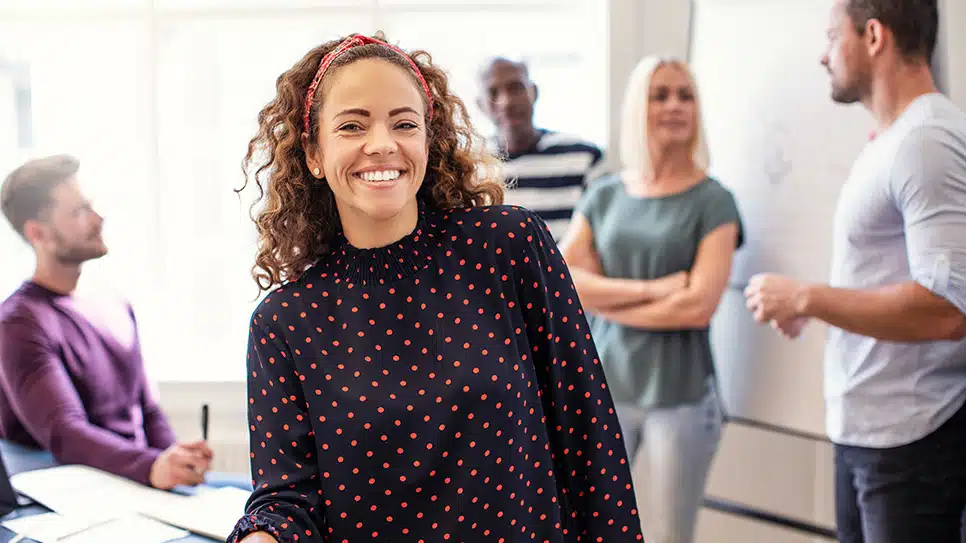 Smiling young designer standing in an office after a meeting