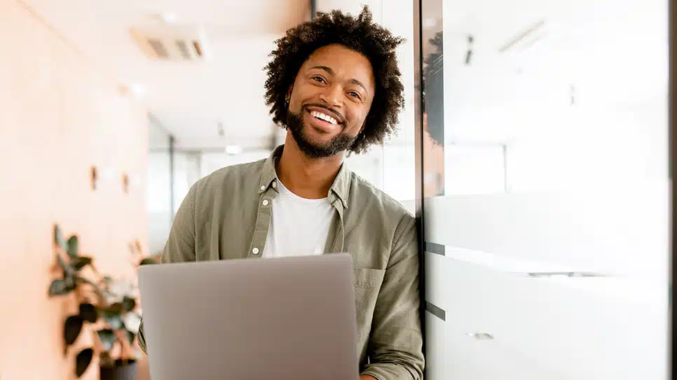 Confident and inspired young african-american businessman looks at the camera