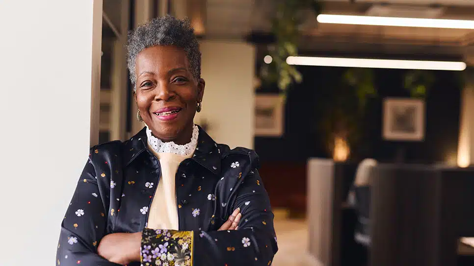 Portrait of confident senior black woman smiling and looking at