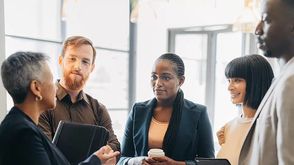 A group of diverse people listening to a manager