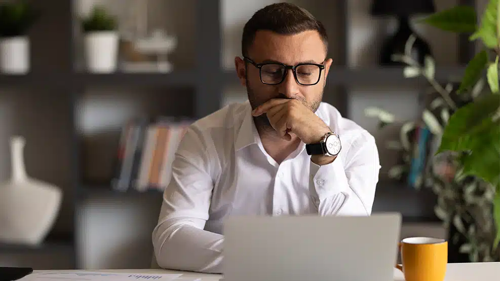 man looking at computer pensively