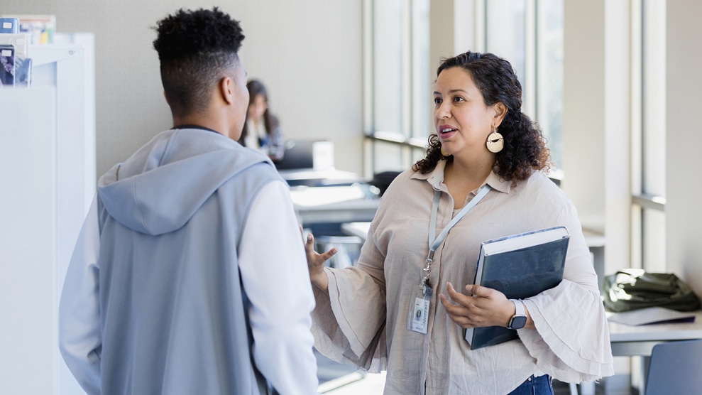 Woman conversing with student