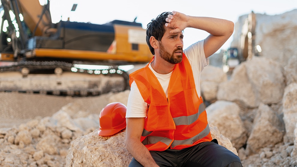 Man at construction site dealing with heat