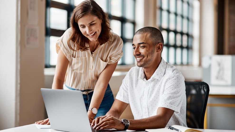 Two colleagues looking at a computer screen